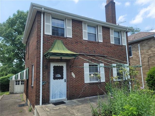 5510 Pocusset St, Squirrel Hill, PA 15217 - view of front of house featuring brick siding and a chimney