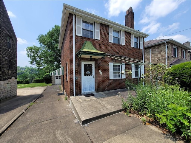 5510 Pocusset St, Squirrel Hill, PA 15217 - view of front facade with brick siding and a chimney