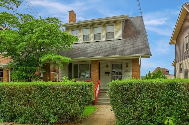 83 Evans Ave, Ingram, PA 15205 - view of front of house with a chimney, a porch, brick siding, and roof with shingles