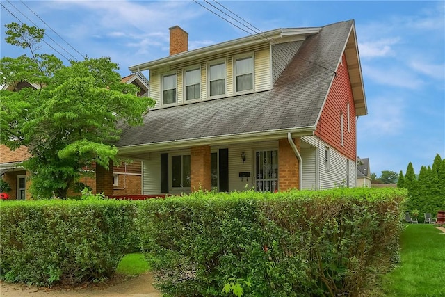 83 Evans Ave, Ingram, PA 15205 - view of front of house featuring a chimney, a porch, and brick siding