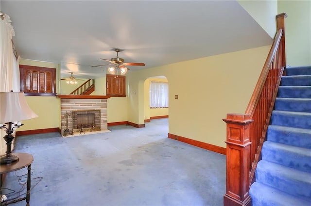 83 Evans Ave, Ingram, PA 15205 - unfurnished living room with ceiling fan, arched walkways, stairs, and a fireplace