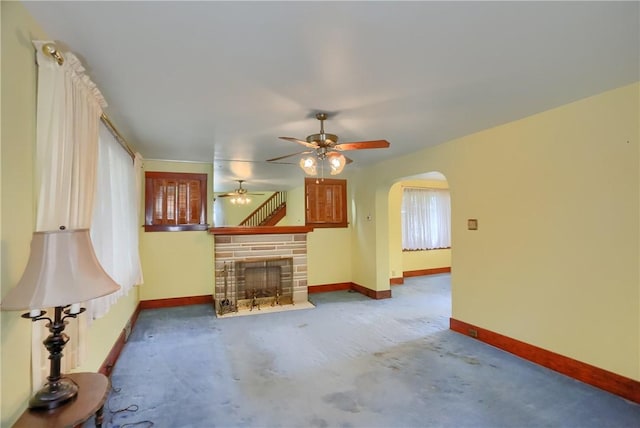 83 Evans Ave, Ingram, PA 15205 - unfurnished living room with arched walkways, a fireplace, and a ceiling fan