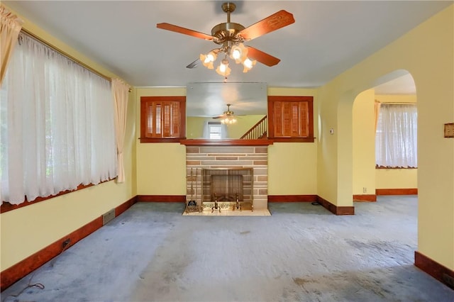 83 Evans Ave, Ingram, PA 15205 - unfurnished living room with a ceiling fan, arched walkways, a stone fireplace, and carpet floors