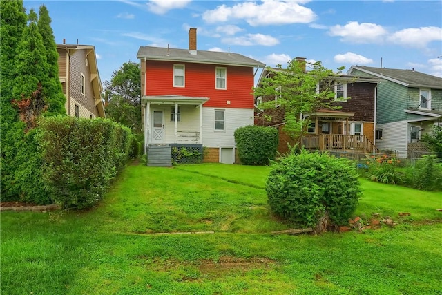 83 Evans Ave, Ingram, PA 15205 - rear view of property with a lawn, a chimney, and a porch