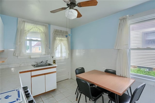 83 Evans Ave, Ingram, PA 15205 - dining space with healthy amount of natural light, tile walls, light tile patterned floors, a ceiling fan, and a wainscoted wall