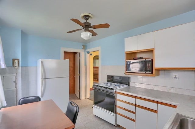 83 Evans Ave, Ingram, PA 15205 - kitchen featuring white appliances, ceiling fan, white cabinets, light countertops, and light tile patterned floors