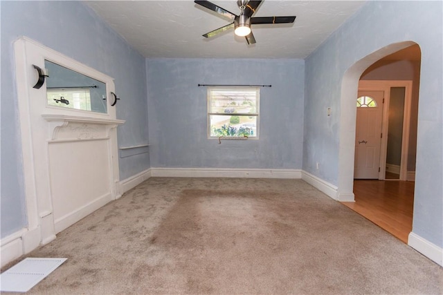 1632 Norwalk St, Crafton Heights, PA 15205 - unfurnished living room featuring carpet flooring, arched walkways, and a ceiling fan