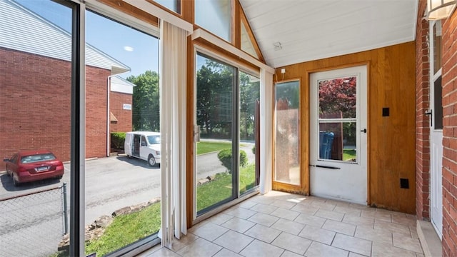 6623 Saltsburg Rd, Penn Hills, PA 15235 - unfurnished sunroom with lofted ceiling, wooden walls, and tile patterned flooring