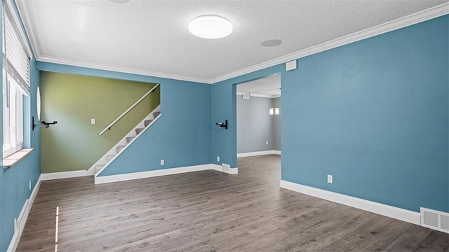 6623 Saltsburg Rd, Penn Hills, PA 15235 - spare room with crown molding, stairway, wood finished floors, and a textured ceiling
