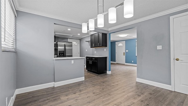 6623 Saltsburg Rd, Penn Hills, PA 15235 - kitchen featuring stainless steel fridge with ice dispenser, crown molding, light countertops, wood finished floors, and dark cabinetry
