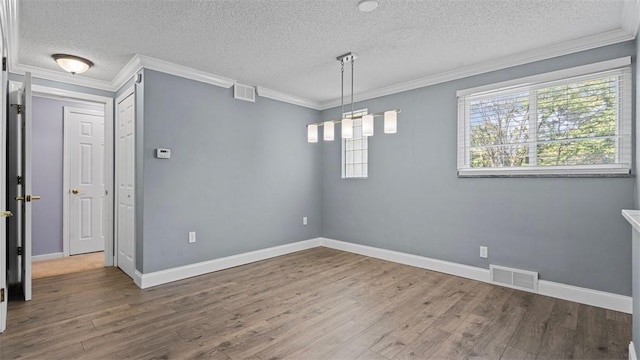 6623 Saltsburg Rd, Penn Hills, PA 15235 - empty room featuring wood finished floors, a textured ceiling, and ornamental molding