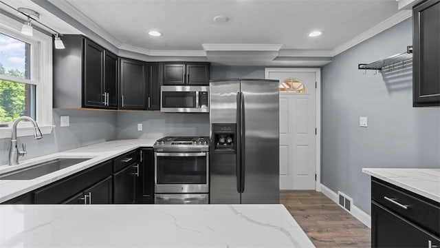 6623 Saltsburg Rd, Penn Hills, PA 15235 - kitchen featuring appliances with stainless steel finishes, dark cabinets, crown molding, wood finished floors, and recessed lighting