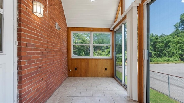 6623 Saltsburg Rd, Penn Hills, PA 15235 - unfurnished sunroom featuring brick wall, tile patterned floors, and wooden walls
