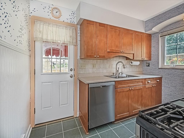449 Woodland Rd, Canonsburg, PA 15317 - kitchen with dishwasher, light countertops, brown cabinets, dark tile patterned floors, and wainscoting