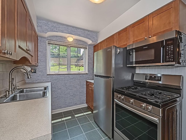 449 Woodland Rd, Canonsburg, PA 15317 - kitchen featuring appliances with stainless steel finishes, dark tile patterned floors, brown cabinets, light countertops, and tasteful backsplash