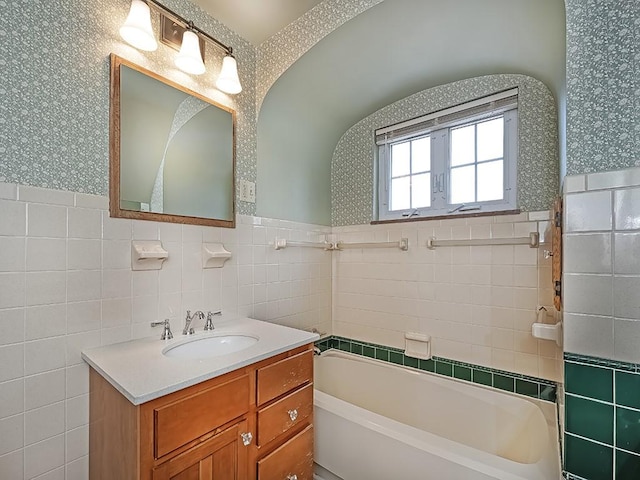 449 Woodland Rd, Canonsburg, PA 15317 - bathroom with wallpapered walls, tile walls, a tub, vanity, and a wainscoted wall