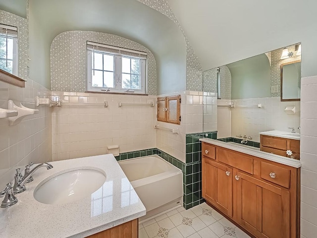 449 Woodland Rd, Canonsburg, PA 15317 - bathroom with tile walls, plenty of natural light, a garden tub, tile patterned floors, and two vanities