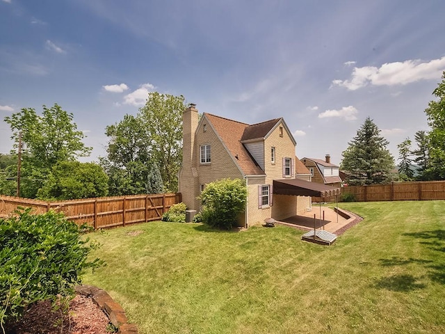 449 Woodland Rd, Canonsburg, PA 15317 - rear view of house with a fenced backyard, a chimney, and a patio