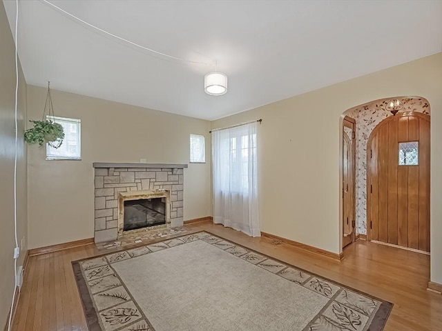 449 Woodland Rd, Canonsburg, PA 15317 - unfurnished living room with wood finished floors, a fireplace, and arched walkways
