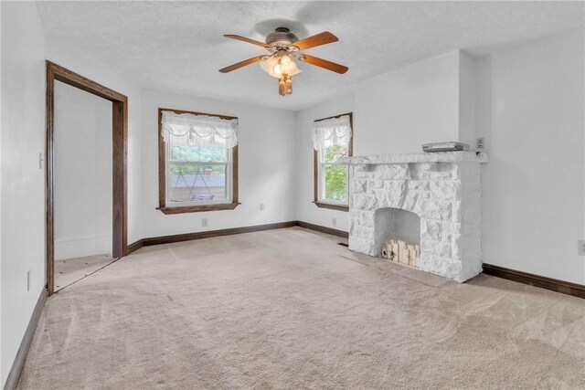 104 Highland Ave, Avella, PA 15312 - unfurnished living room featuring carpet flooring, a fireplace, a ceiling fan, and a textured ceiling