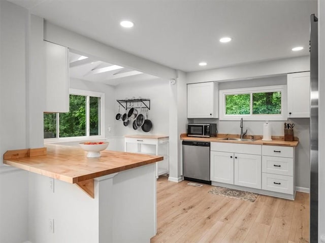 537 Ambridge Ave, Leet Twp, PA 15003 - kitchen with wooden counters, stainless steel dishwasher, white cabinetry, recessed lighting, and beam ceiling