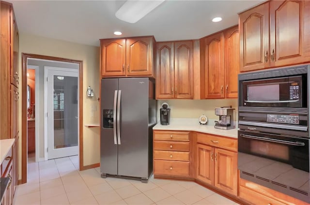 143 Hampshire Dr, Cranberry Twp, PA 16066 - kitchen with black appliances, light countertops, light tile patterned floors, brown cabinetry, and recessed lighting