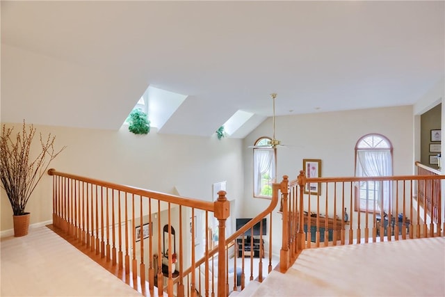 143 Hampshire Dr, Cranberry Twp, PA 16066 - hall with an upstairs landing, healthy amount of natural light, a skylight, vaulted ceiling, and carpet