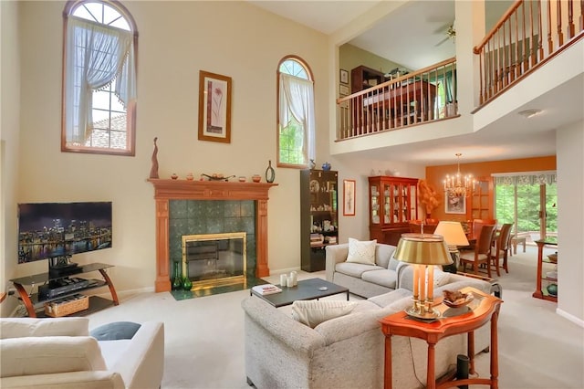 143 Hampshire Dr, Cranberry Twp, PA 16066 - carpeted living room with a tiled fireplace, a towering ceiling, and a chandelier