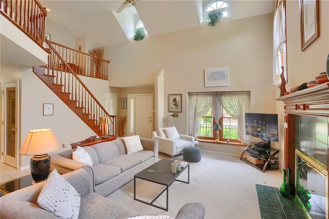 143 Hampshire Dr, Cranberry Twp, PA 16066 - living area featuring a towering ceiling, stairway, a ceiling fan, carpet floors, and a tiled fireplace