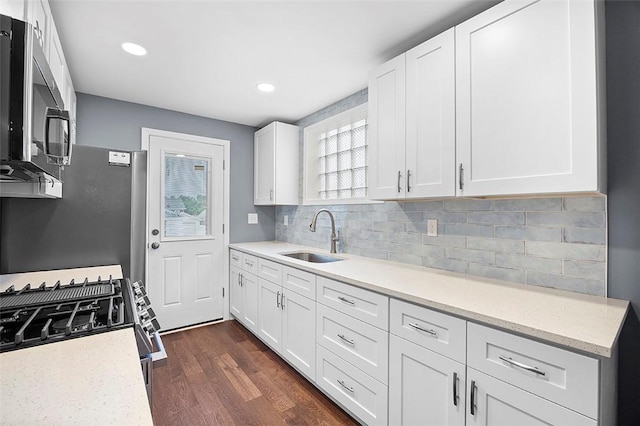 1014 Fordham Ave, Brookline, PA 15226 - kitchen featuring appliances with stainless steel finishes, dark wood-style flooring, white cabinetry, tasteful backsplash, and recessed lighting