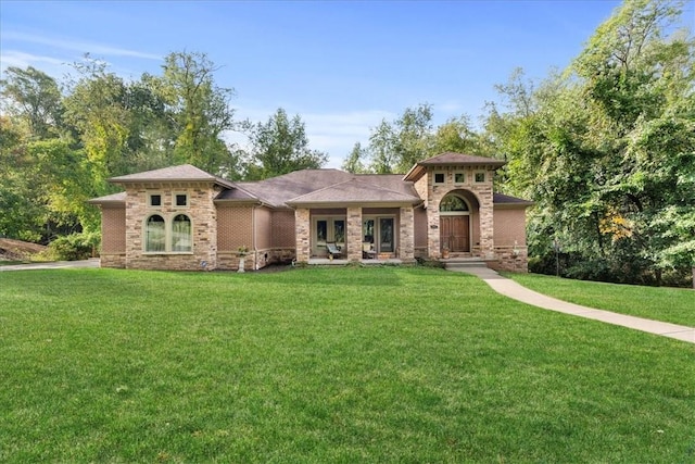 912 Field Club Rd, Ohara, PA 15238 - mediterranean / spanish home featuring a front lawn, brick siding, and french doors