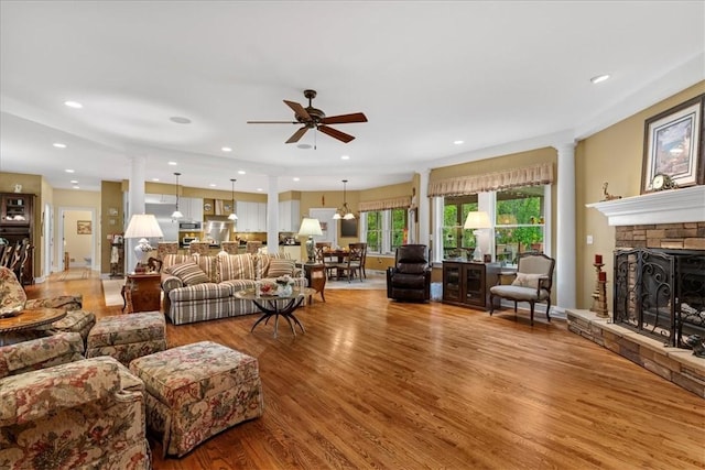 912 Field Club Rd, Ohara, PA 15238 - living room with decorative columns, wood finished floors, a ceiling fan, a stone fireplace, and recessed lighting