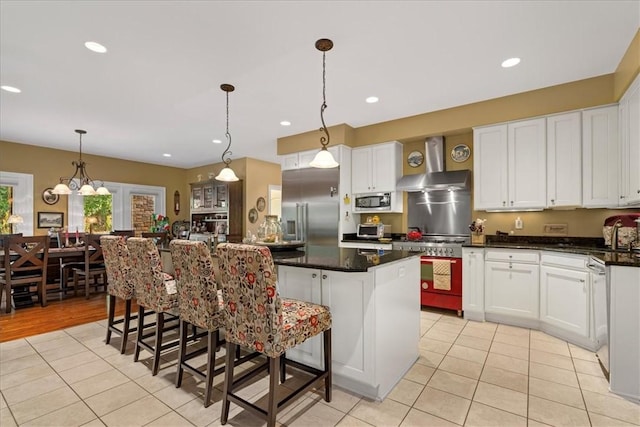 912 Field Club Rd, Ohara, PA 15238 - kitchen with built in appliances, light tile patterned flooring, wall chimney exhaust hood, white cabinetry, and a center island
