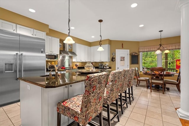 912 Field Club Rd, Ohara, PA 15238 - kitchen with appliances with stainless steel finishes, light tile patterned floors, white cabinets, a kitchen island with sink, and recessed lighting