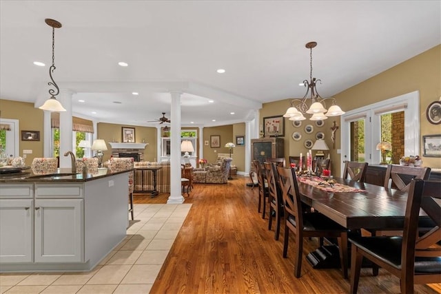 912 Field Club Rd, Ohara, PA 15238 - dining room featuring healthy amount of natural light, ornate columns, a fireplace, ceiling fan, and recessed lighting
