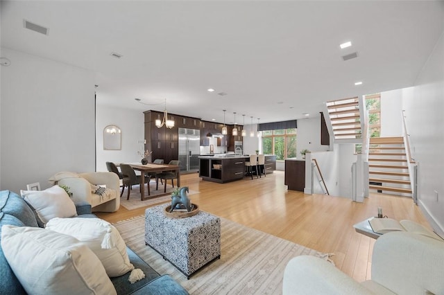 1821 Merriman, South Side, PA 15203 - living area with light wood-style floors, recessed lighting, a chandelier, and stairway