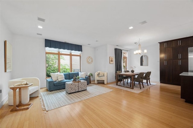 1821 Merriman, South Side, PA 15203 - living area featuring light wood finished floors and a chandelier