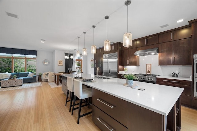 1821 Merriman, South Side, PA 15203 - kitchen featuring appliances with stainless steel finishes, under cabinet range hood, light countertops, and plenty of natural light