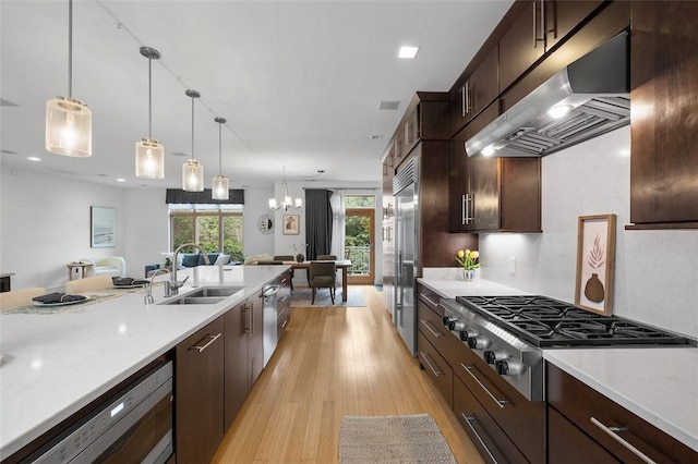 1821 Merriman, South Side, PA 15203 - kitchen featuring exhaust hood, appliances with stainless steel finishes, light wood finished floors, light countertops, and dark brown cabinetry