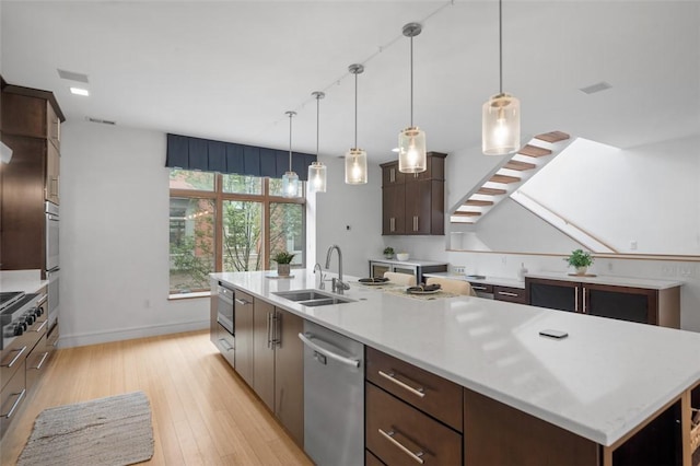 1821 Merriman, South Side, PA 15203 - kitchen with dishwasher, light wood-style flooring, light countertops, and dark brown cabinets