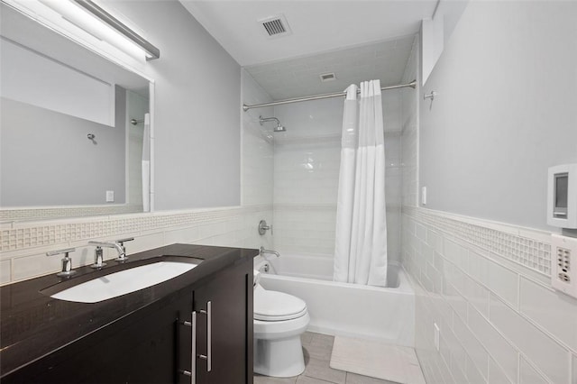 1821 Merriman, South Side, PA 15203 - full bathroom featuring tile walls, shower / bath combo with shower curtain, vanity, tile patterned floors, and a wainscoted wall