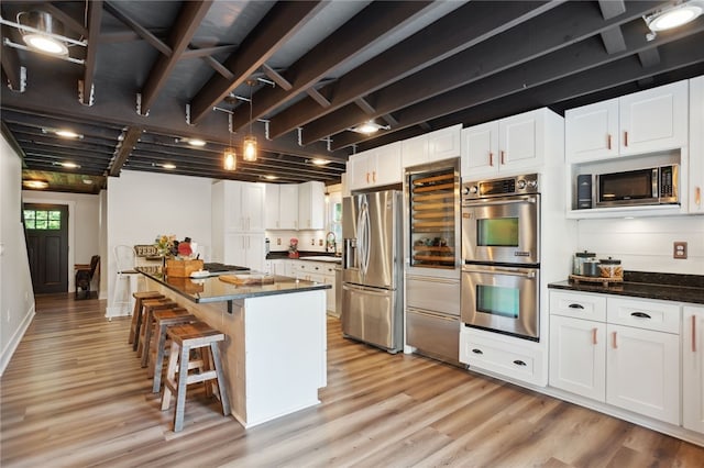 812 Franklin Rd, Pine Twp Nal, PA 16046 - kitchen with stainless steel appliances, light wood-style flooring, white cabinetry, a kitchen breakfast bar, and a kitchen island