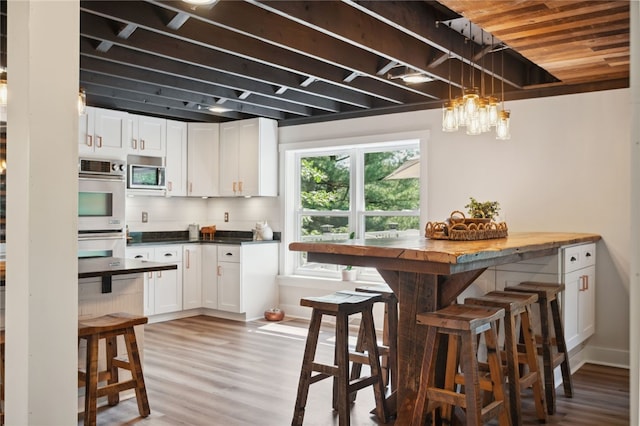 812 Franklin Rd, Pine Twp Nal, PA 16046 - kitchen with stainless steel appliances, white cabinets, light wood-style flooring, and pendant lighting