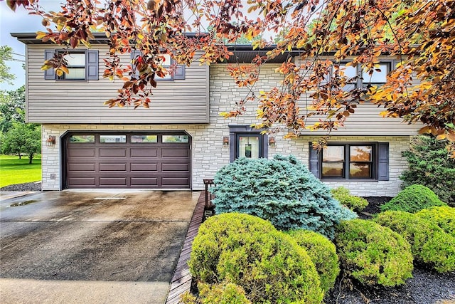14042 Easy St, North Huntingdon, PA 15642 - view of front facade with an attached garage, driveway, and stone siding
