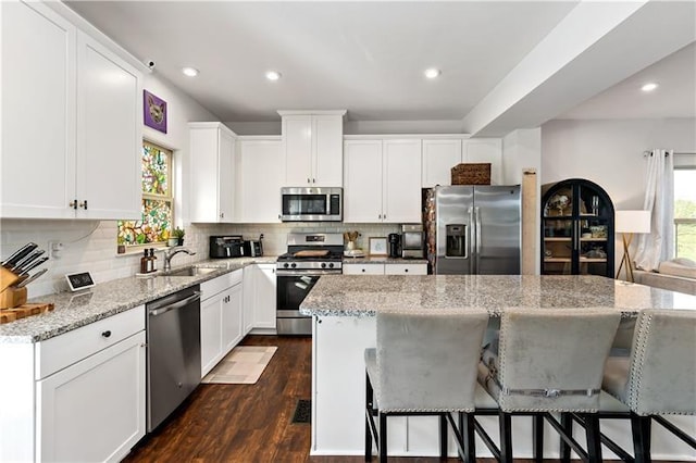 4002 Saint Andrews Ct, Penn Twp Wml, PA 15644 - kitchen with stainless steel appliances, a center island, tasteful backsplash, light stone countertops, and recessed lighting