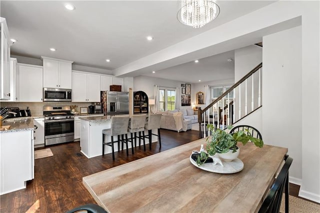4002 Saint Andrews Ct, Penn Twp Wml, PA 15644 - dining space with stairs, dark wood-type flooring, recessed lighting, and a chandelier