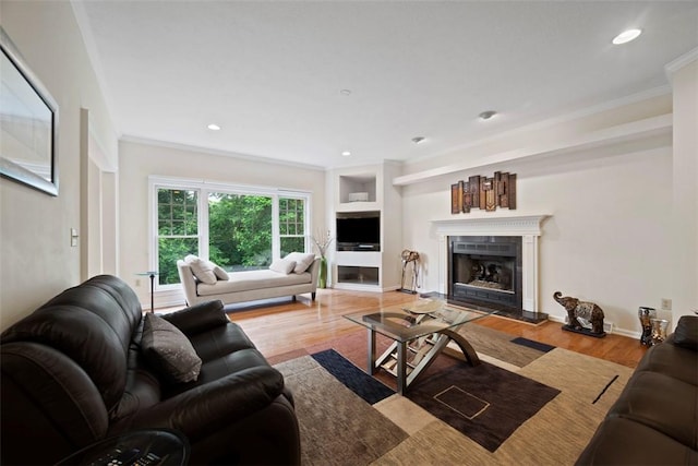 7052 Bennington Woods Dr, Mccandless, PA 15237 - living area featuring crown molding, wood finished floors, a fireplace with raised hearth, and recessed lighting