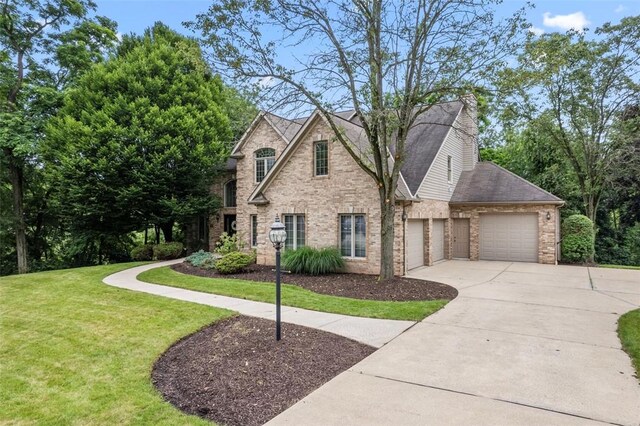 7052 Bennington Woods Dr, Mccandless, PA 15237 - view of front of house featuring an attached garage, concrete driveway, a front lawn, and brick siding