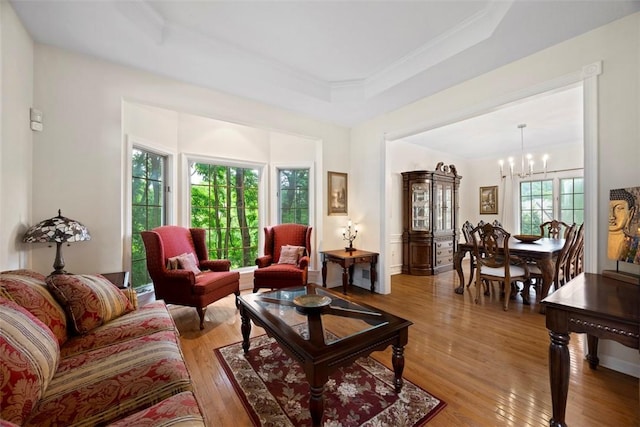 7052 Bennington Woods Dr, Mccandless, PA 15237 - living area with a raised ceiling, a chandelier, light wood-type flooring, and ornamental molding