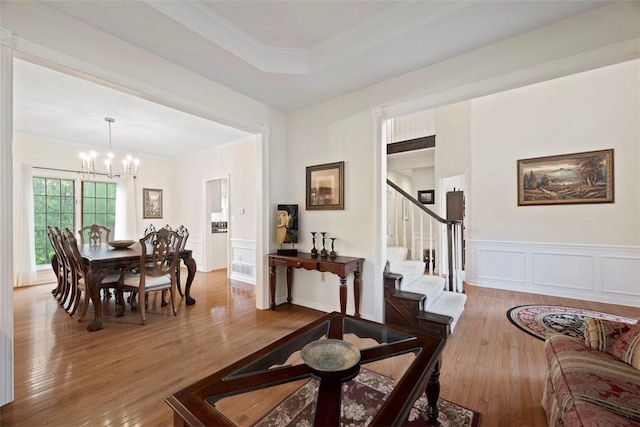 7052 Bennington Woods Dr, Mccandless, PA 15237 - dining area with a chandelier, wood finished floors, a decorative wall, stairway, and wainscoting